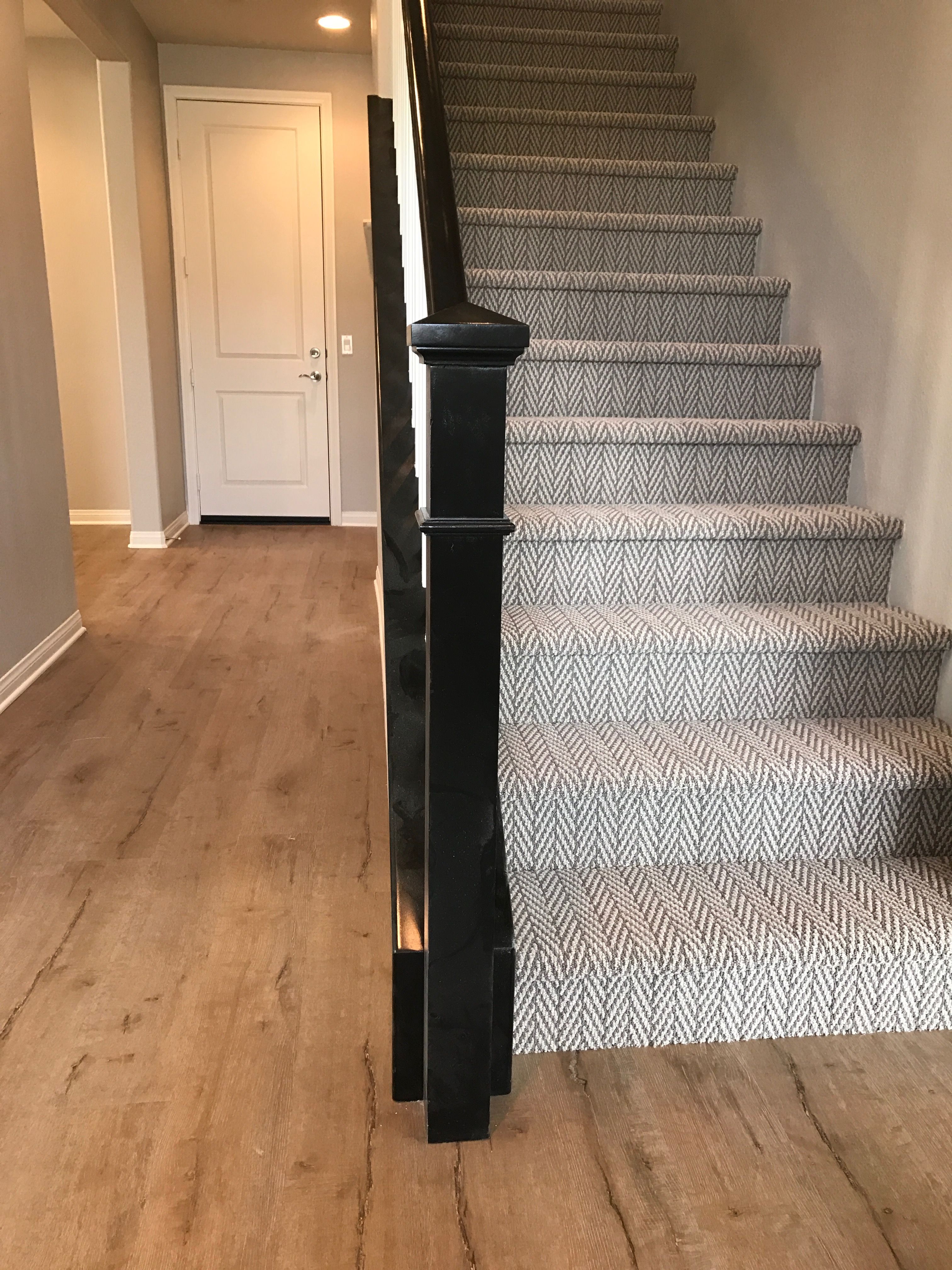 Tuftex Only Natural. I love my new carpet on these stairs. It holds up to kids and pets. High traffic stairs. Herringbone carpet on back stairs with wood floors. Dark stair rails with white. Neutral s…