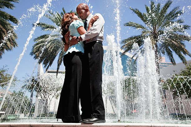 Couple Hugging And Kissing At Fountain
