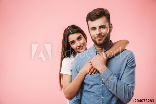 Portrait Of A Smiling Young Couple Hugging